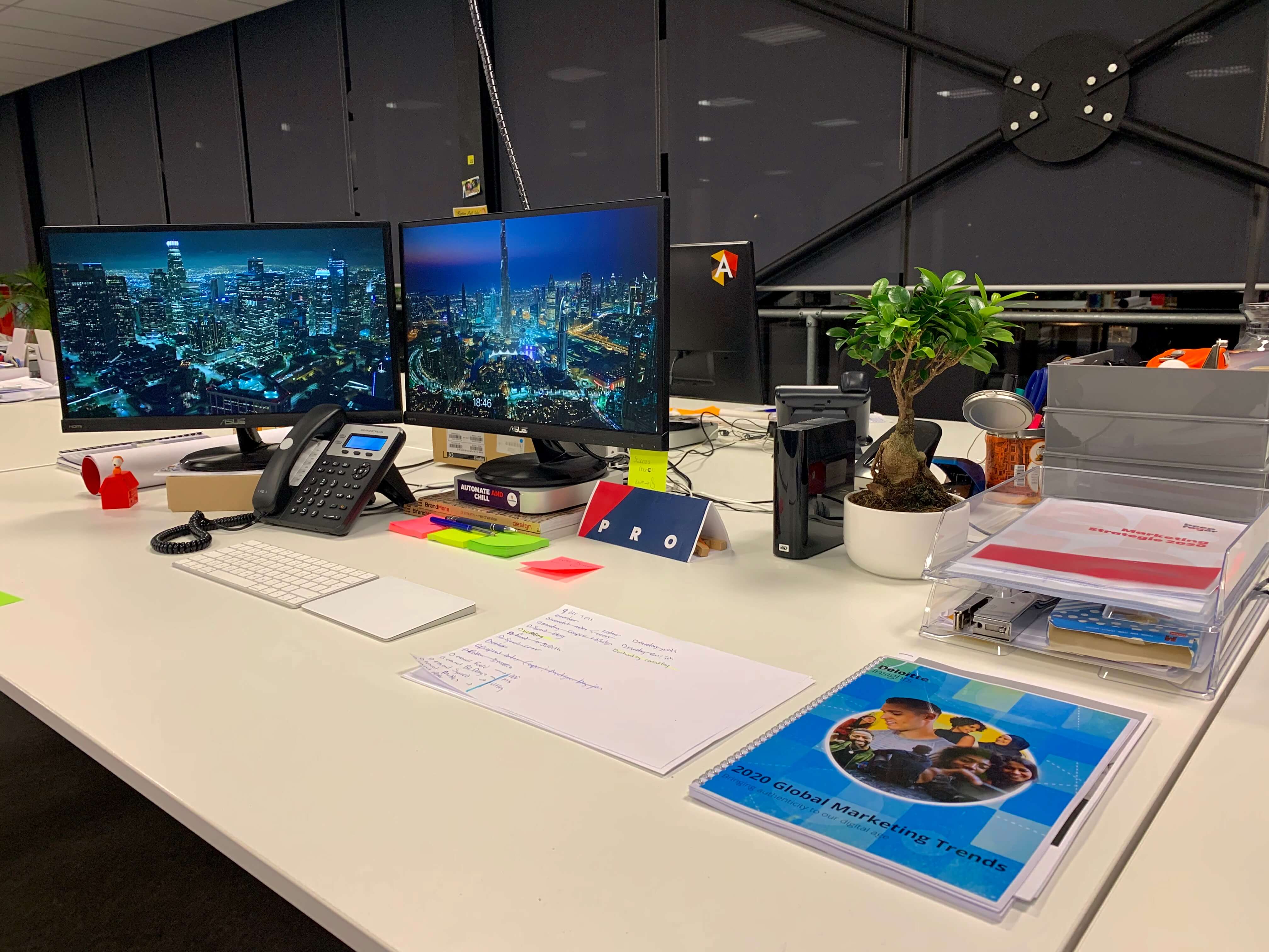 Marc's desk cluttered with handwriting notes on journals, sticky notes, and papers.